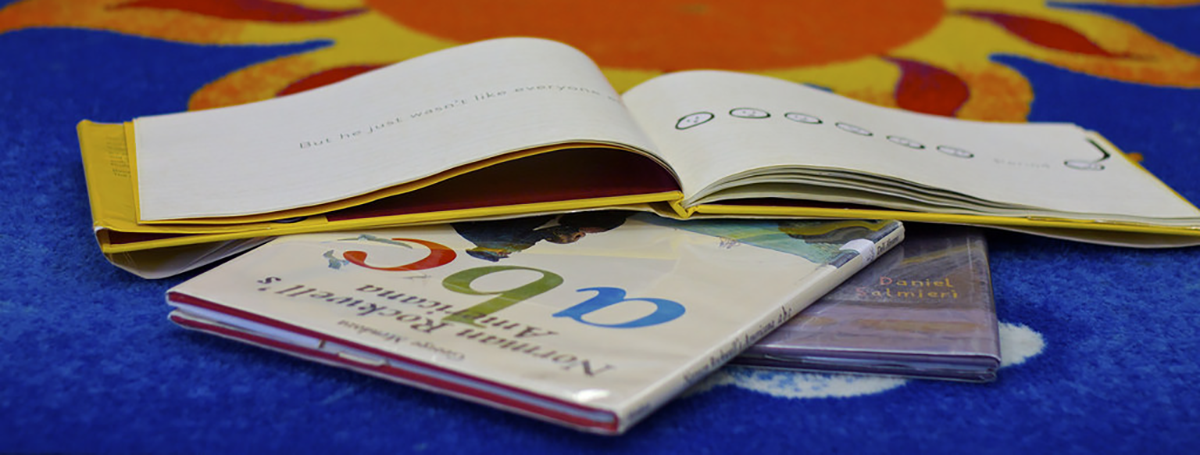 Children's books spread on colorful carpet Children's books spread on colorful carpet