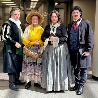 Actors from The Live Oak Playhouse portray William Shakespeare, Mother Goose, Elizabeth Barrett Browning, and Edgar Allan Poe.