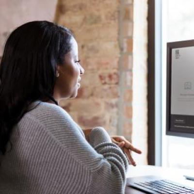 Woman sitting at a desktop computer