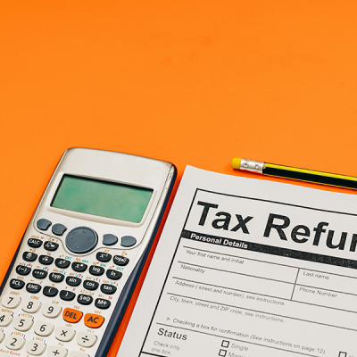 Tax help image showing a tax refund form and a calculator