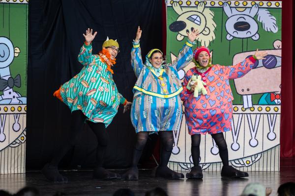 3 actors, from Houston Grand Opera's Opera to Go, wave at an unseen audience.