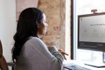 Woman sitting at a desktop computer