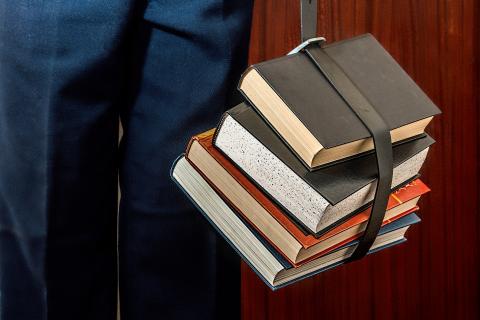 student holding books
