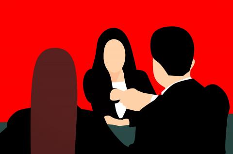 three people talking in an office setting