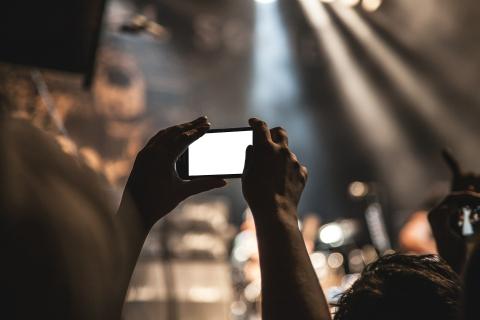 person taking video with smartphone