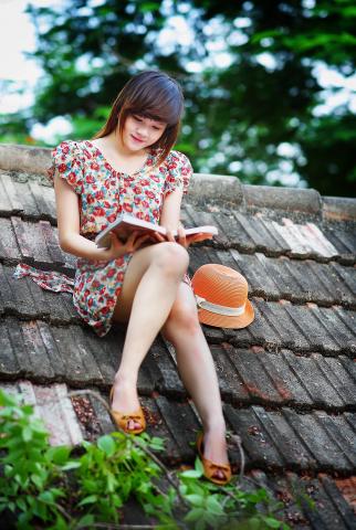 teen girl reading on roof