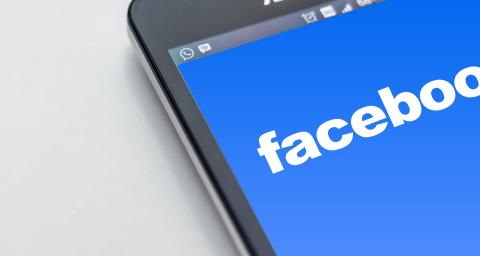 mobile phone with facebook logo displayed on it