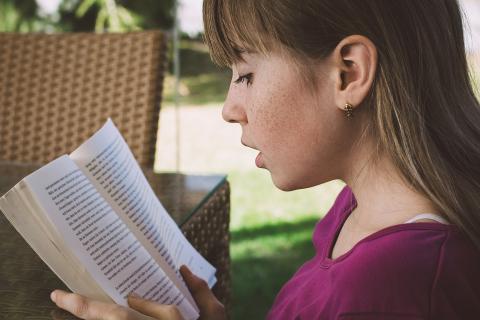 young girl reading a book
