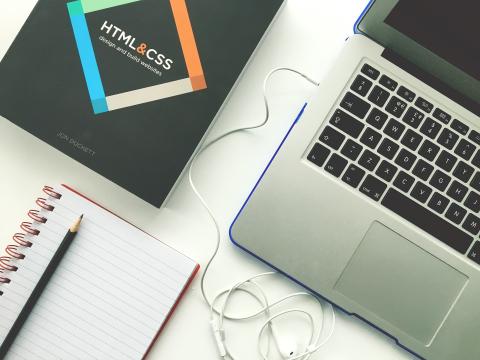 computer with web designing book