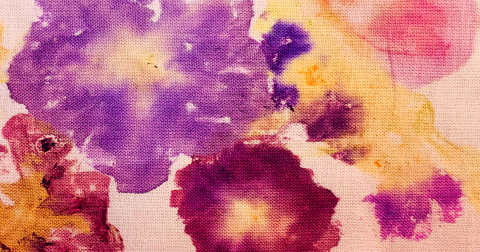 Purple, pinkm and white pansy prints on fabric. 