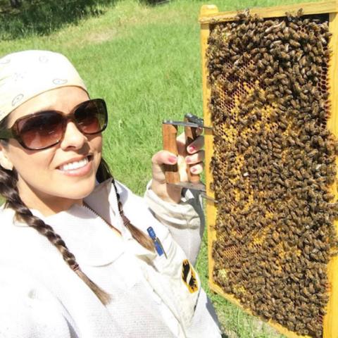 Image of Danessa Yaschuk with a hive