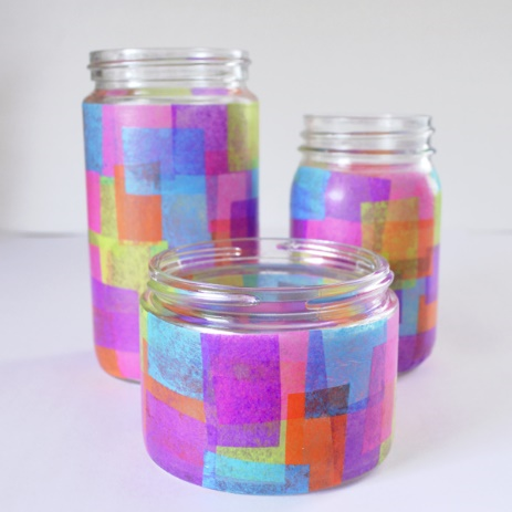 close up of a photo of glasses that have modpodged tissue paper on it making it look like stained glass