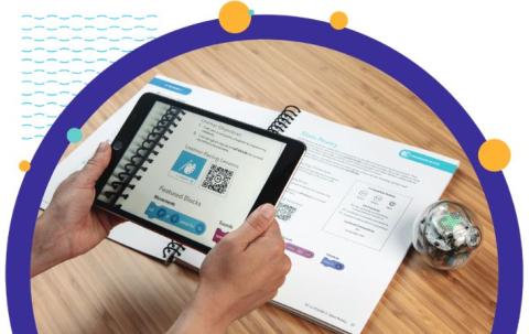 close of someone programming a sphero robot with a tablet