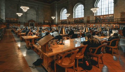 photo of students studying in a dimly lit univsersity