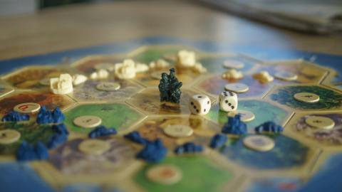 Game piece and dice on a game board