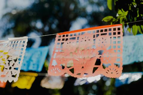 Hanging papel picado cut in the shape of a pot of flowers