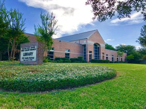 Exterior of First Colony Branch Library, with library sign.