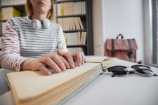 Woman reading a braille book in a library