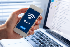 Person holding a smartphone with the words "Wifi Connect" and the wifi symbol displayed on the screen