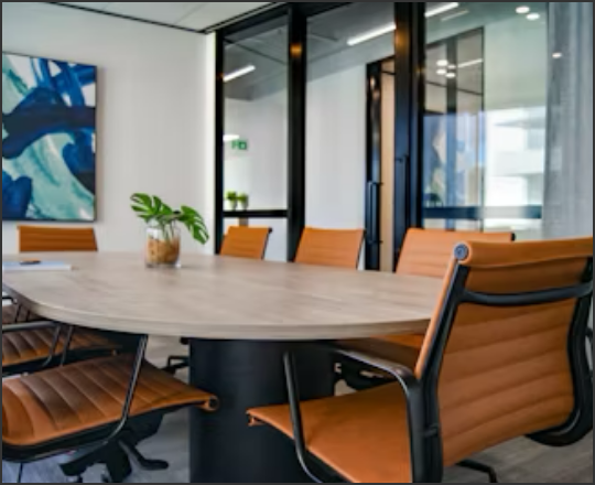 Reserve a Room linked image showing a meeting room with a table and seven chairs