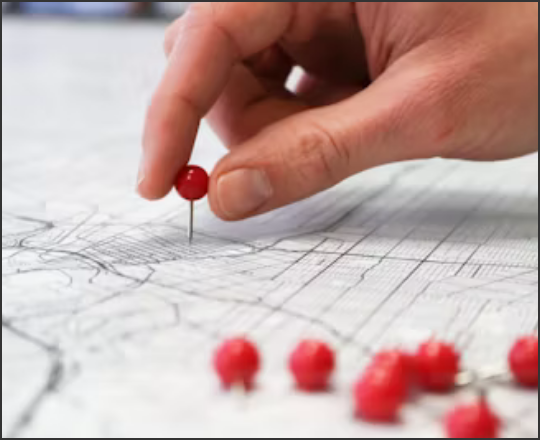 Locations and Hours linked image showing a person putting a red pin in a map