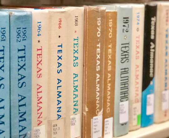 Texas almanacs on shelf