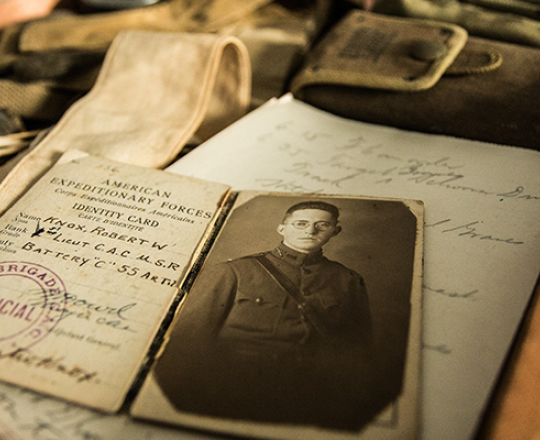 Genealogy documents and a black and white historical photo of a man