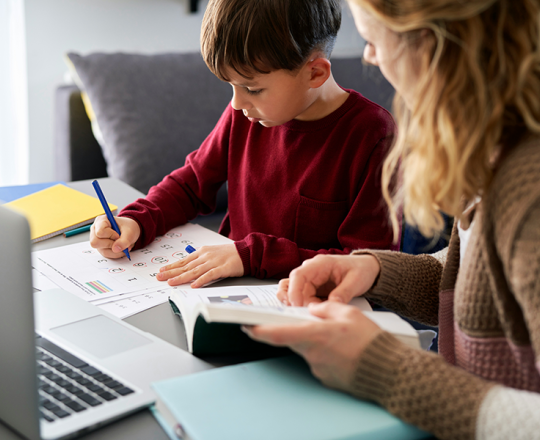 Mom helping son with homework
