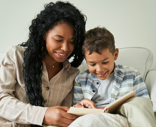 Mom and son reading a book together