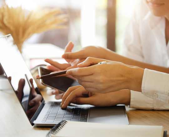 Two people at a laptop pointing at the screen