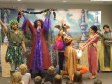 HGO Rapunzel Actors from HGO's Opera to Go group perform a scene from Rapunzel in front of children sitting on the floor.