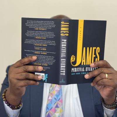 Roosevelt Weeks holding up the book James by Percival Everett